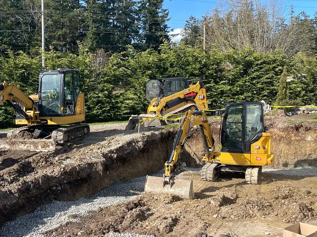 Whidbey Dirt Works excavators digging a trench on an island jobsite