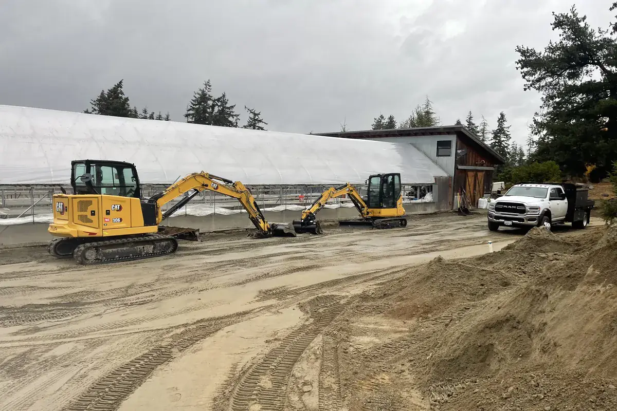 Excavators shaping and grading a site